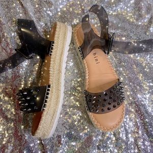 Black plastic and stud heels